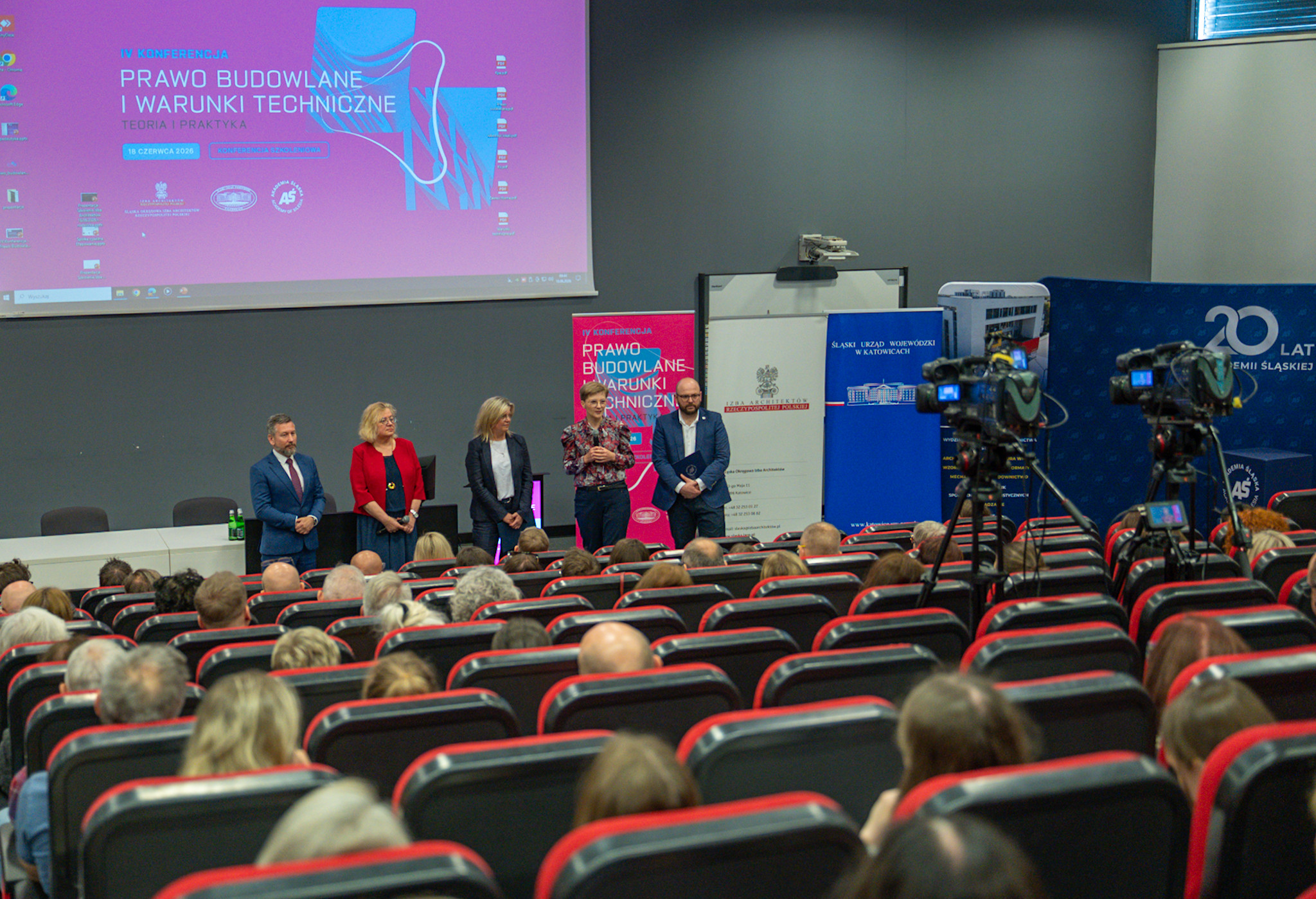 Sala wypełniona uczestnikami konferencji.